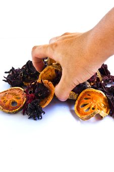 Hand Is Picking Dried Bael And Roselle Royalty Free Stock Images