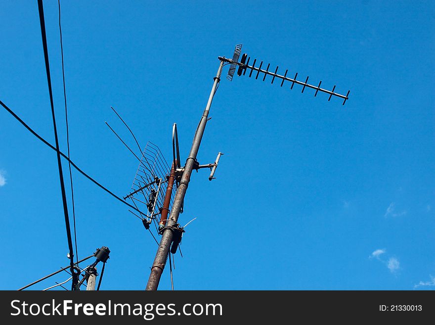 Old metal antenna over blue sky