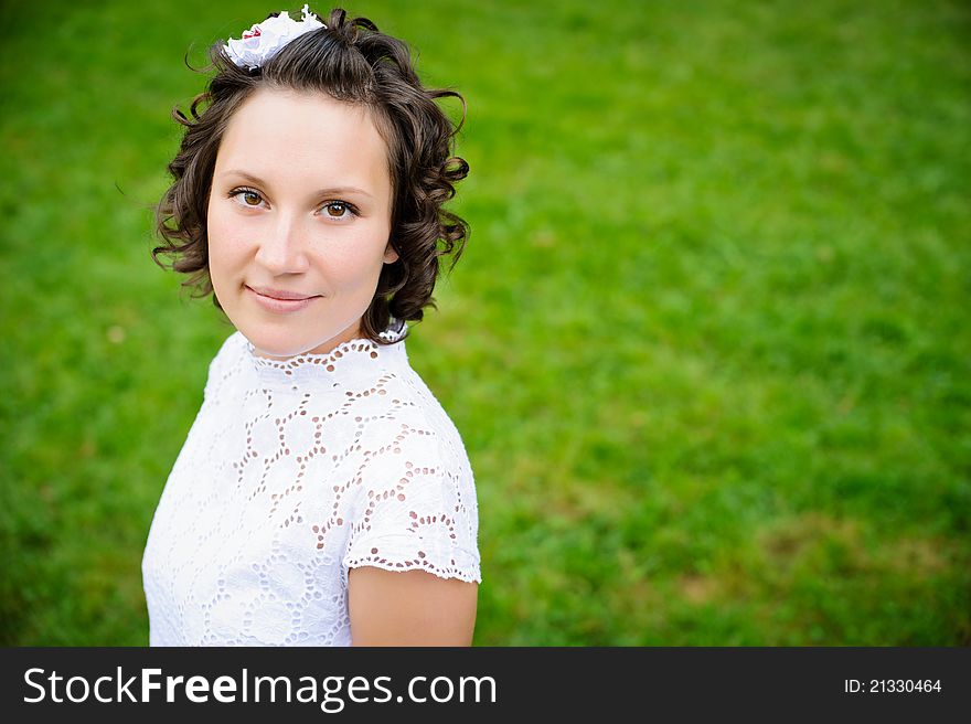 Portrait of beautiful young woman on the green grass background. Portrait of beautiful young woman on the green grass background