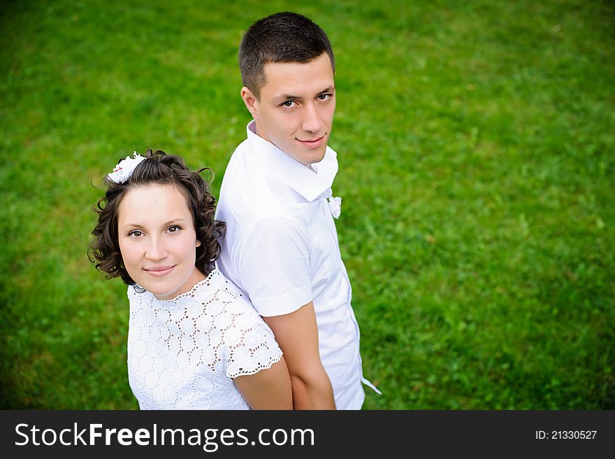 Portrait of beautiful young women and men on the green grass background. Portrait of beautiful young women and men on the green grass background