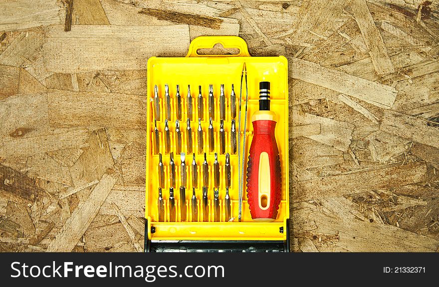 Put a box set of screwdrivers.Placed on a wooden floor.