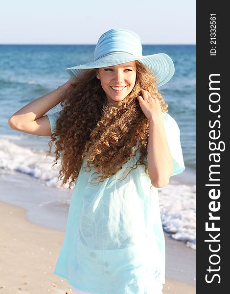 Young happy woman on sea background