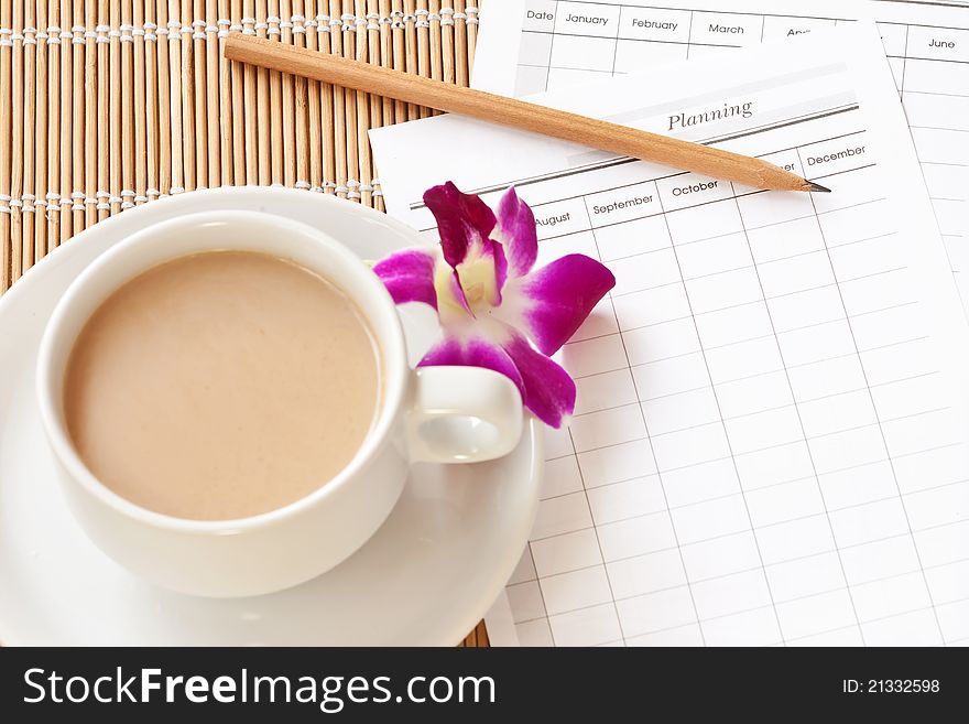A cup of coffee cup with planning paper