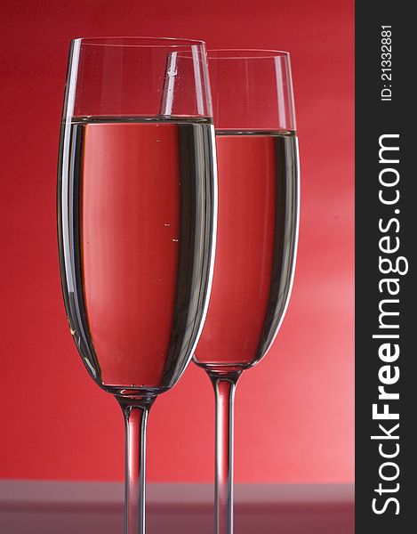 Two wineglasses of champagne  over colored  background
