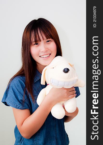 Portrait of young asian woman with her doll on white background