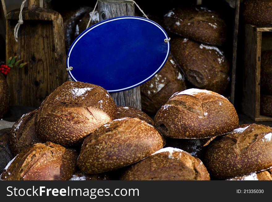 Fresh bread on a market with an empty blue sign