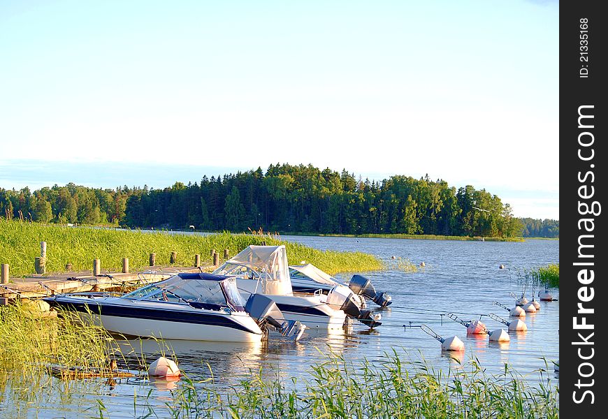 Boats at bay, at the pier, at summer, blue sky and water