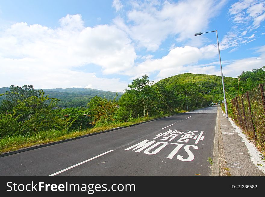 Road Against The Blue Sky With White Clouds