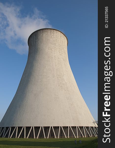 Cooling tower in power plant. Blue sky in background.