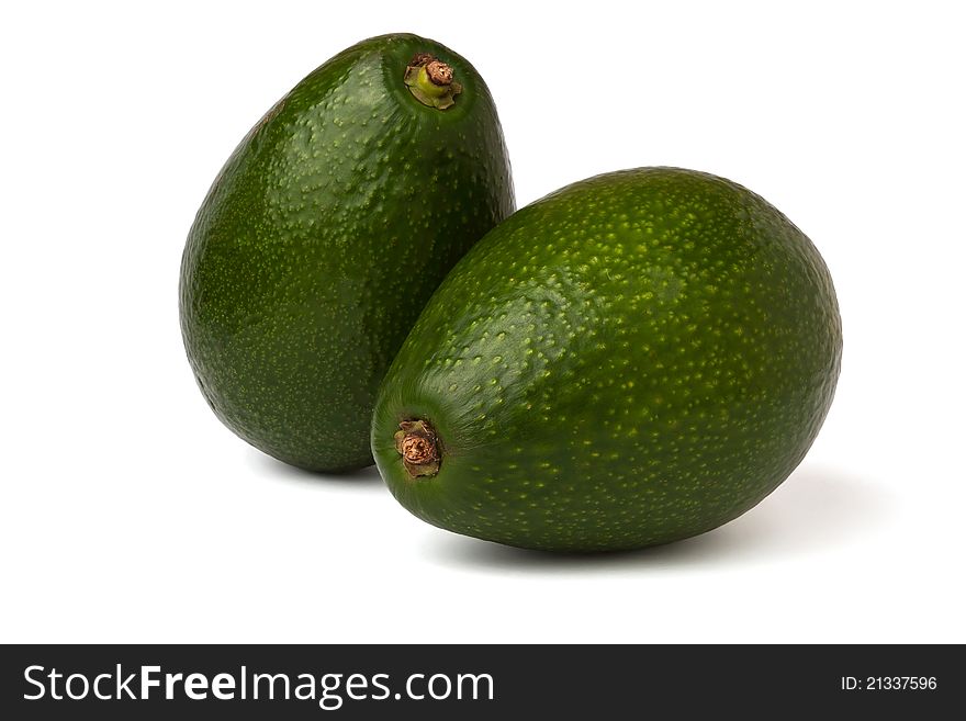 Two avocados against white background