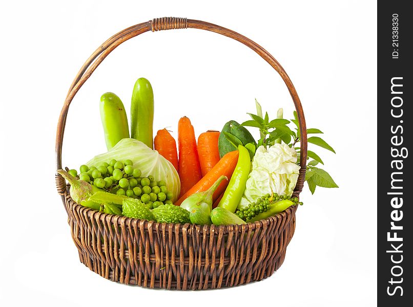 Vegetables in basket isolated on white background