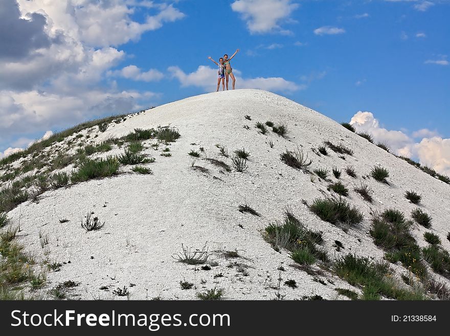 Two girls on a hilltop.