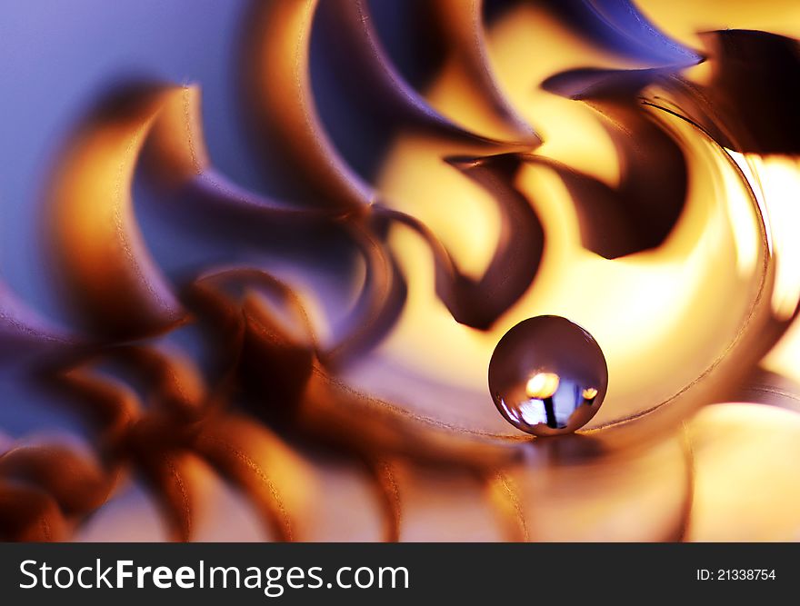 A glass marble on fire from paper. A glass marble on fire from paper