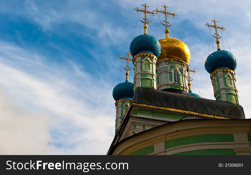 Orthodox domes of russian church and cloud on sky. Russian historic town