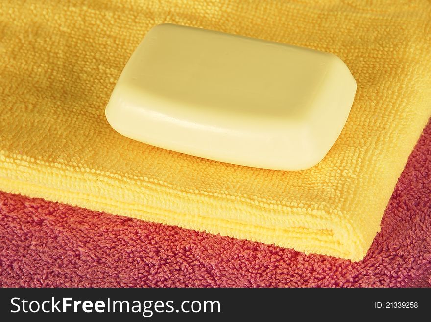 Magenta and yellow towels with white soap bar. Magenta and yellow towels with white soap bar