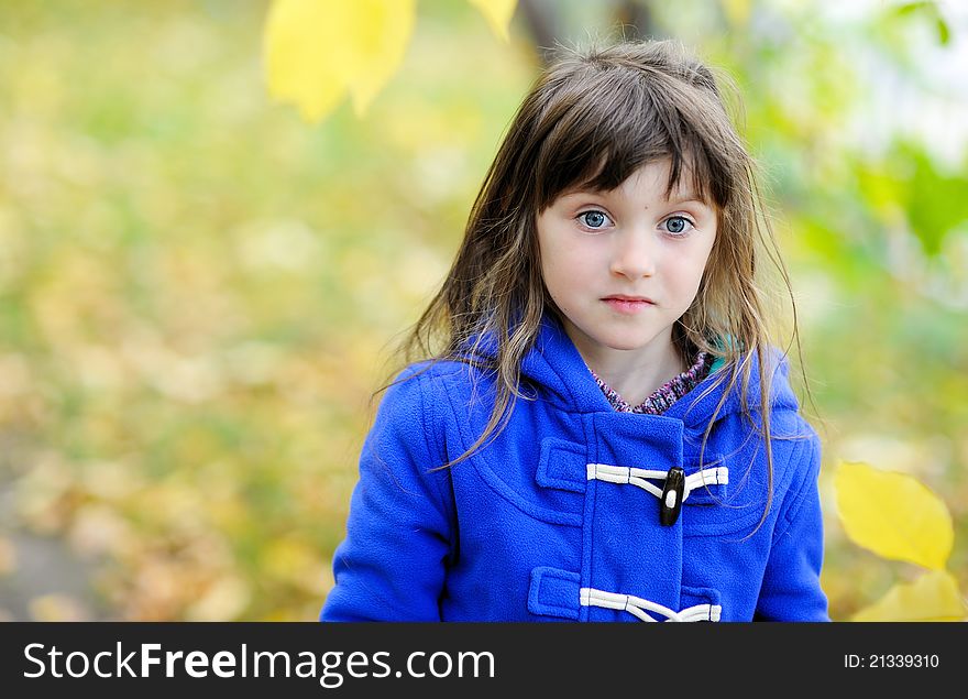 Outdoor portrait of funky little girl in blue coat. Outdoor portrait of funky little girl in blue coat