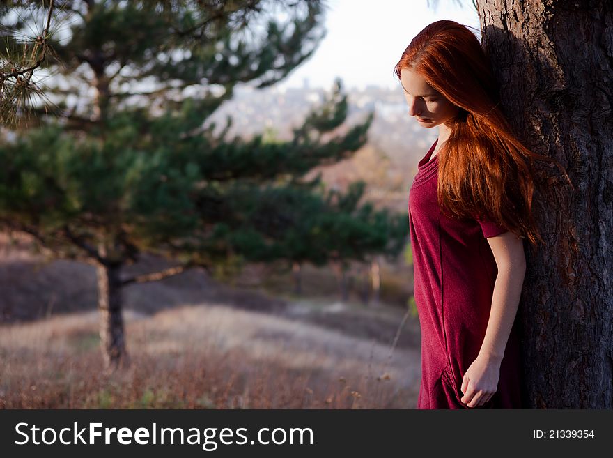 Portrait of a beautiful redhead girl in the spring garden. Portrait of a beautiful redhead girl in the spring garden