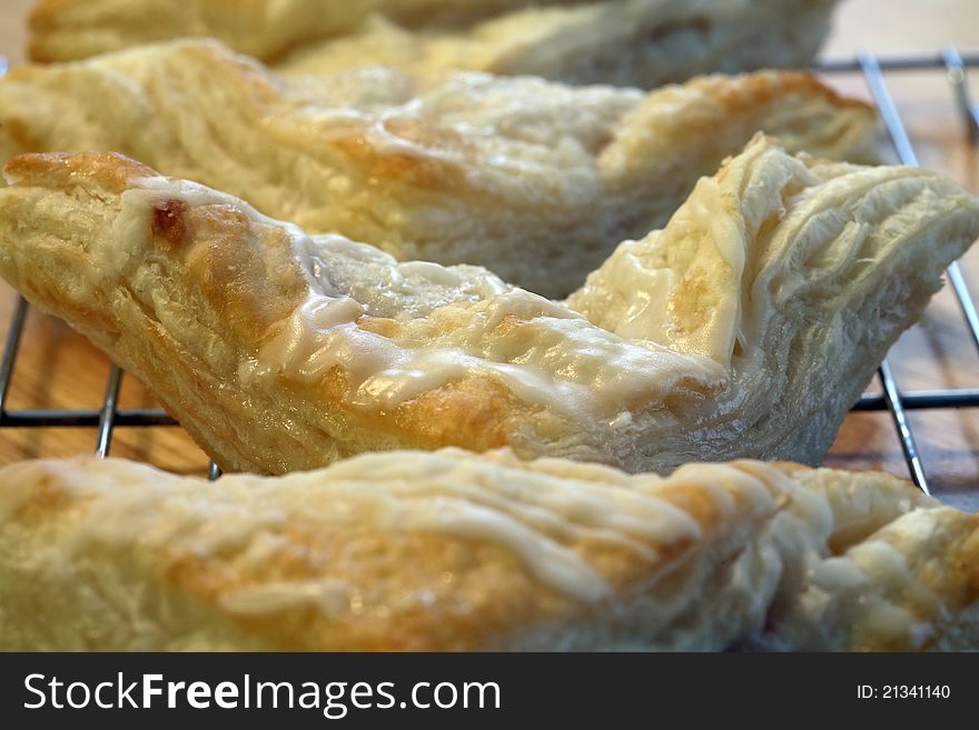 Fresh baked turnovers cooling on a cooling rack. Fresh baked turnovers cooling on a cooling rack