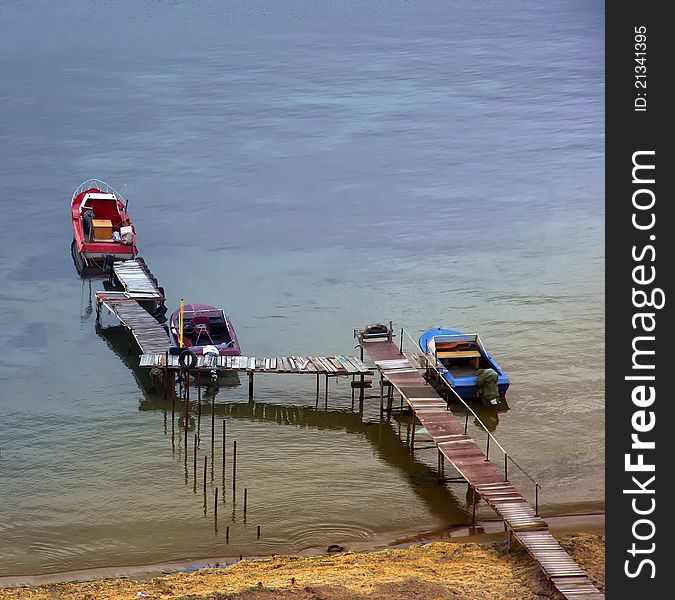 Three fishing boats in  blue waterway