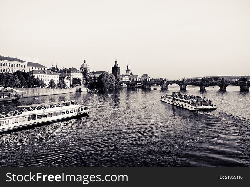 A photo showing two boats on the Vltava river through Prague, the capital of the Czech Republic. The bridge across the river is the famous Charles Bridge. A photo showing two boats on the Vltava river through Prague, the capital of the Czech Republic. The bridge across the river is the famous Charles Bridge