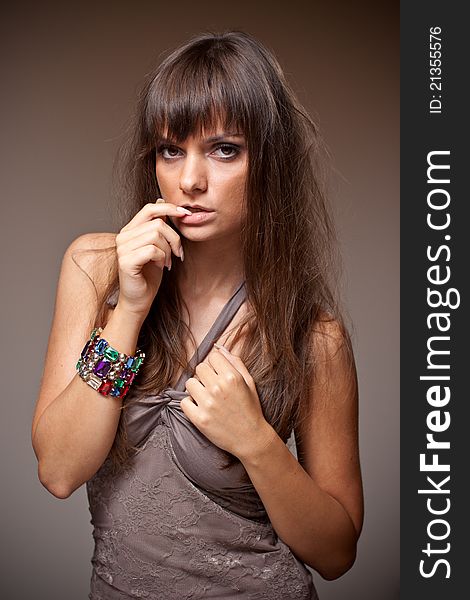 Portrait of beautiful model with long hair and brown shirt. Portrait of beautiful model with long hair and brown shirt