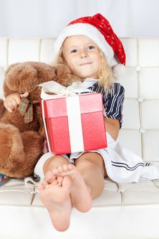 Little Girl In Santa Helper Hat With Gift Stock Photography