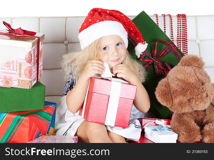 Little Girl In Santa Helper Hat With Gift