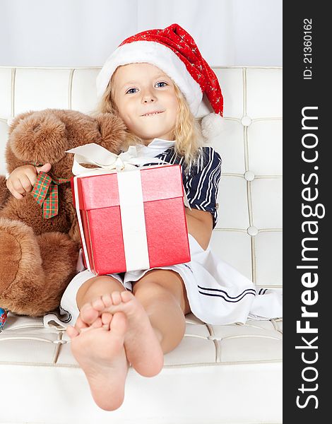 Little Girl In Santa Helper Hat With Gift