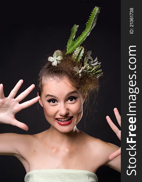 Woman with cactus in her hair on a black background. Woman with cactus in her hair on a black background