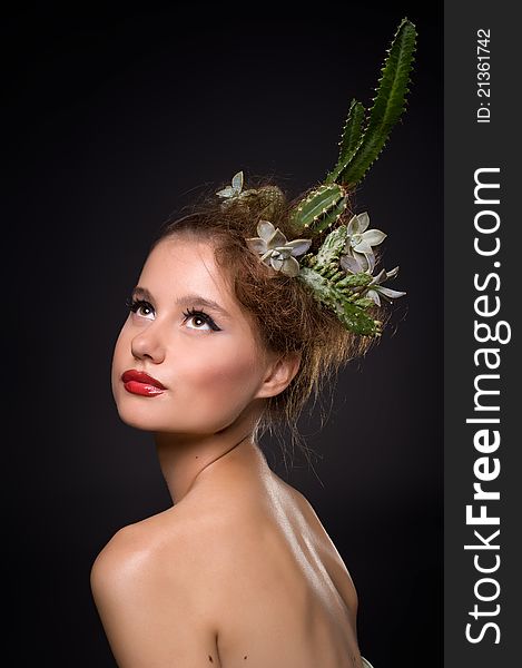 Woman with cactus in her hair on a black background