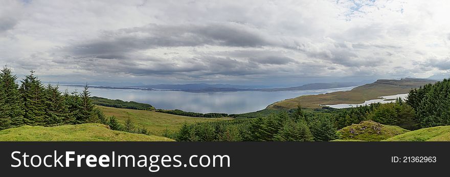 Scottish landscape, hills, heather and a lake.