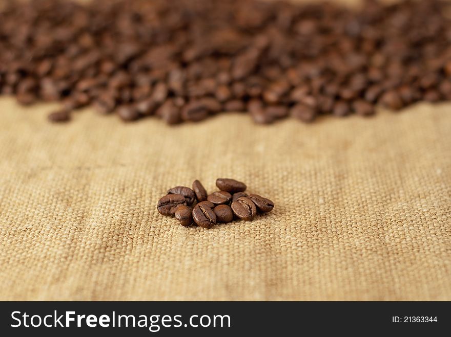 Freshly roasted coffee beans on burlap