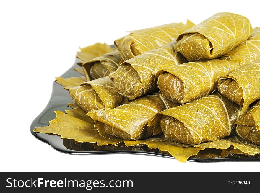 Dolma on a black plate. Isolated on white background. Dolma on a black plate. Isolated on white background.