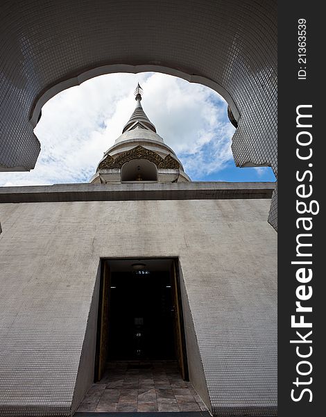 White pagoda in Wat Phra That Pha Ngao on blue sky background