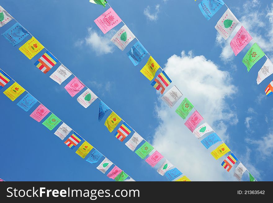 String Of Flags At A Religious Celebration Against Blue Sky. String Of Flags At A Religious Celebration Against Blue Sky