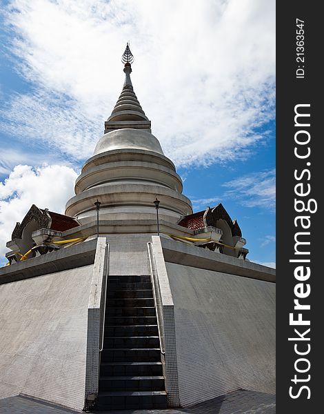 White pagoda in Wat Phra That Pha Ngao on blue sky background