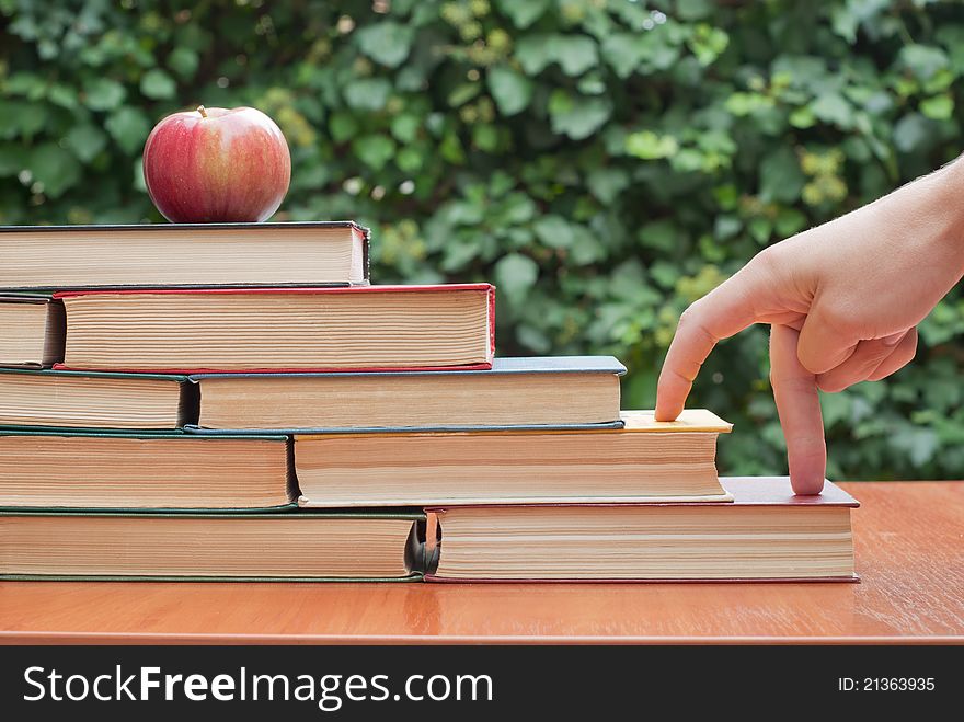 Old books on the table with apple