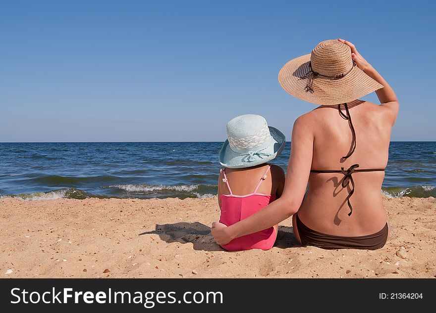 Mother with daughter on beach