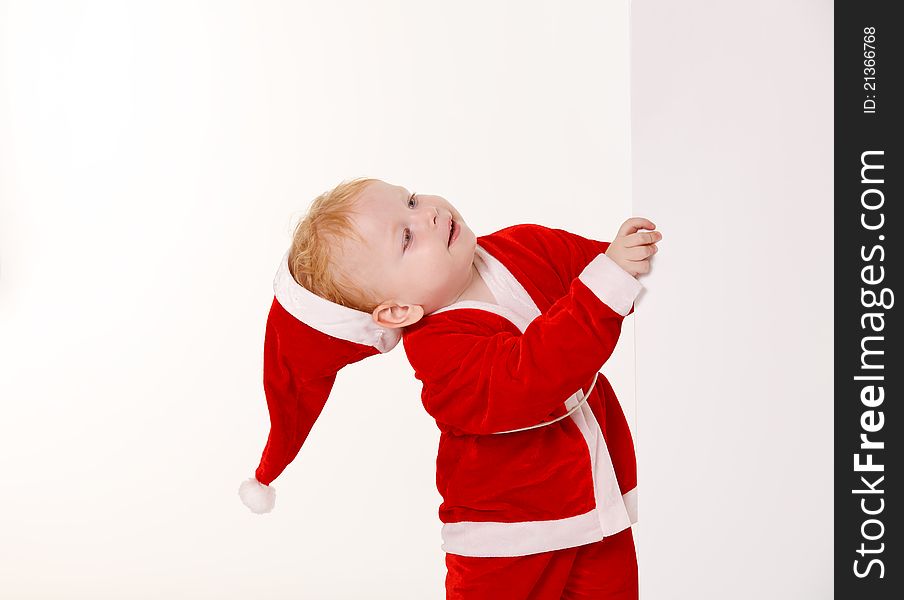 Child dressed as Santa Claus on a white background. Child dressed as Santa Claus on a white background