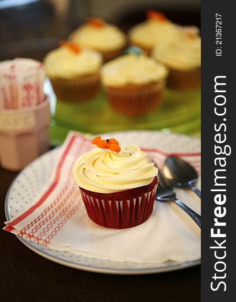 A chocolate cup cake with white cream on top. A chocolate cup cake with white cream on top.