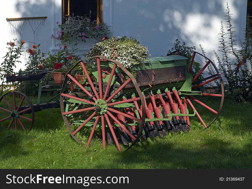 Old agricultural machine with flowers. Old agricultural machine with flowers