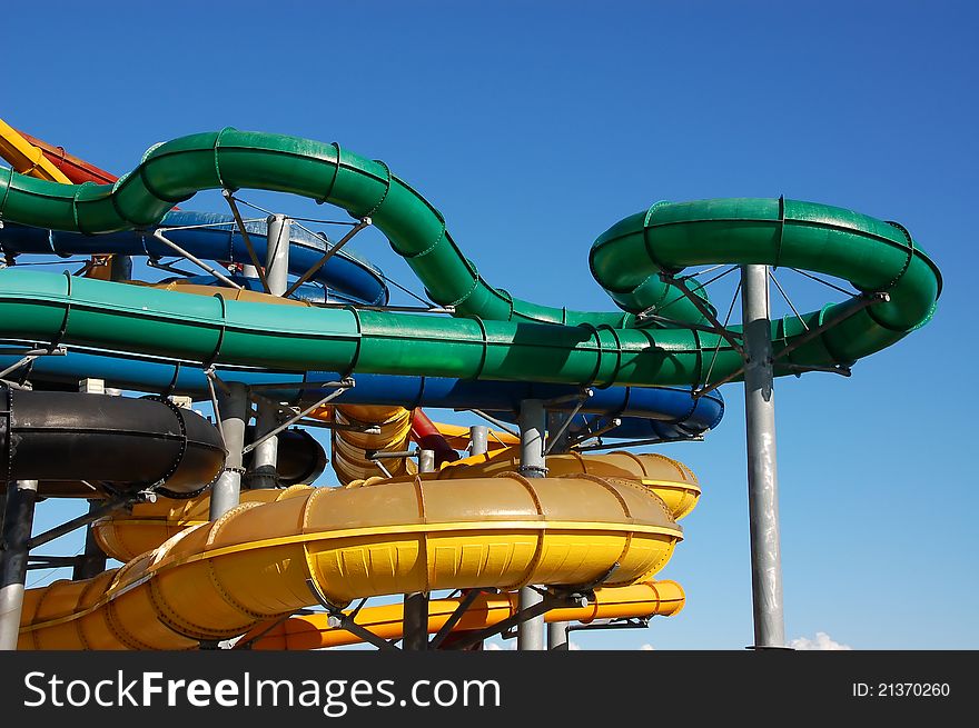 Multi-colored pipes of an aquapark against the blue sky