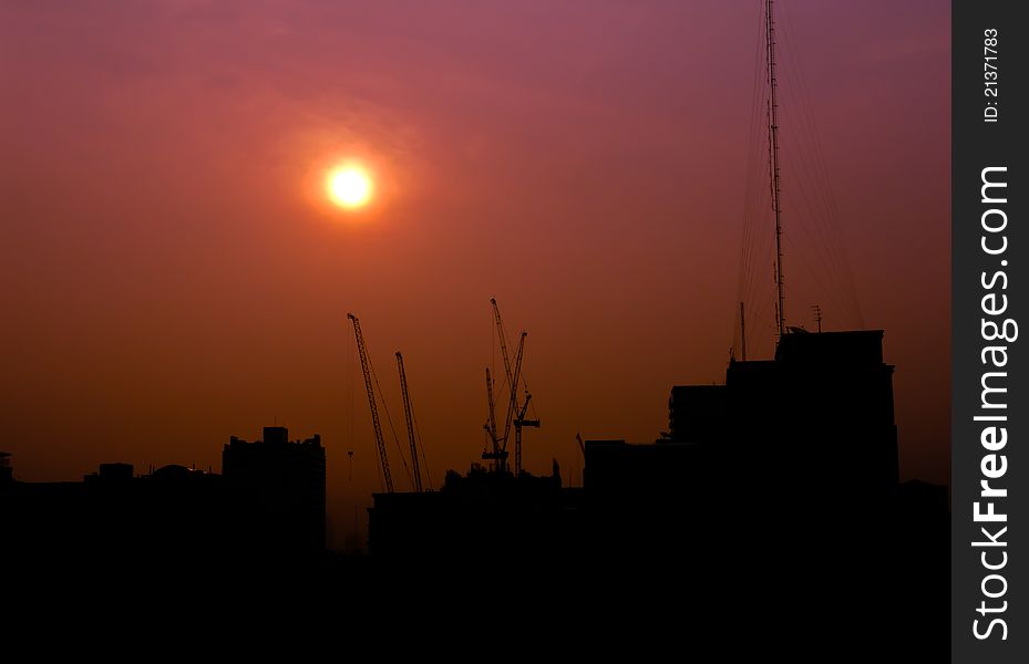 City under construction at sunrise silhouette