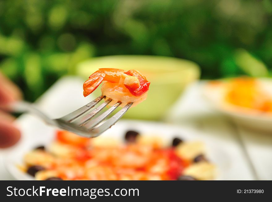 Shrimp on fork and other food background