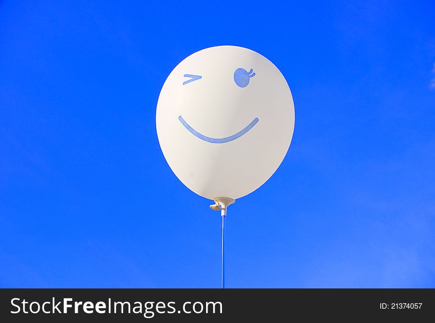 A smilling balloon isolated on blue
