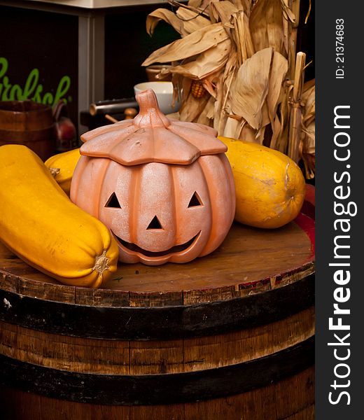Ceramic pumpkin and zucchini on a barrel. Ceramic pumpkin and zucchini on a barrel.