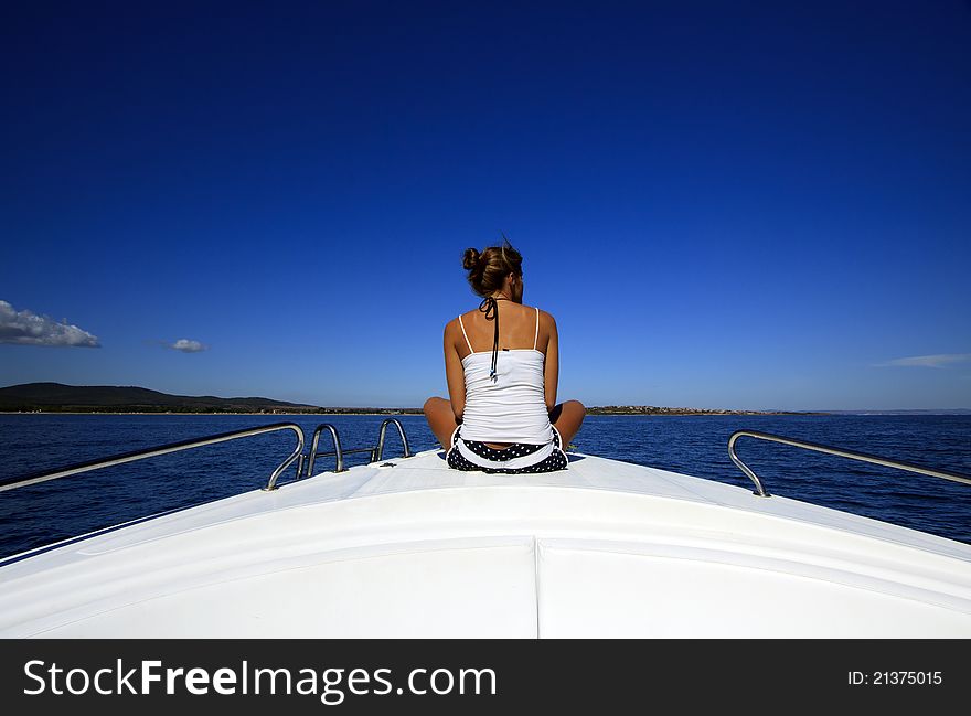 Young woman looking at sea on board the boat