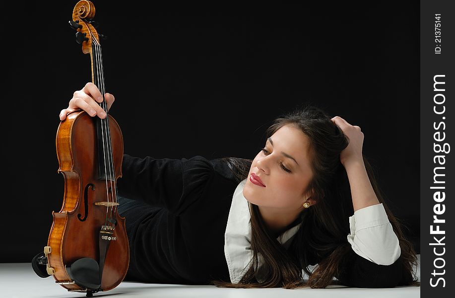 Pretty girl with violin isolated on black