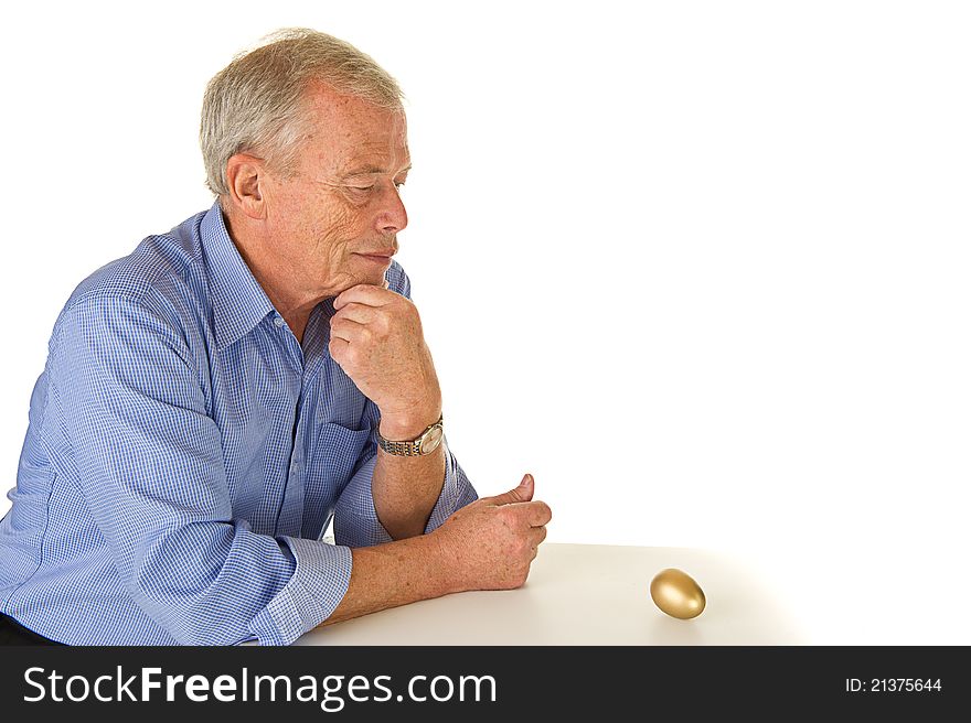 Senior man with golden egg