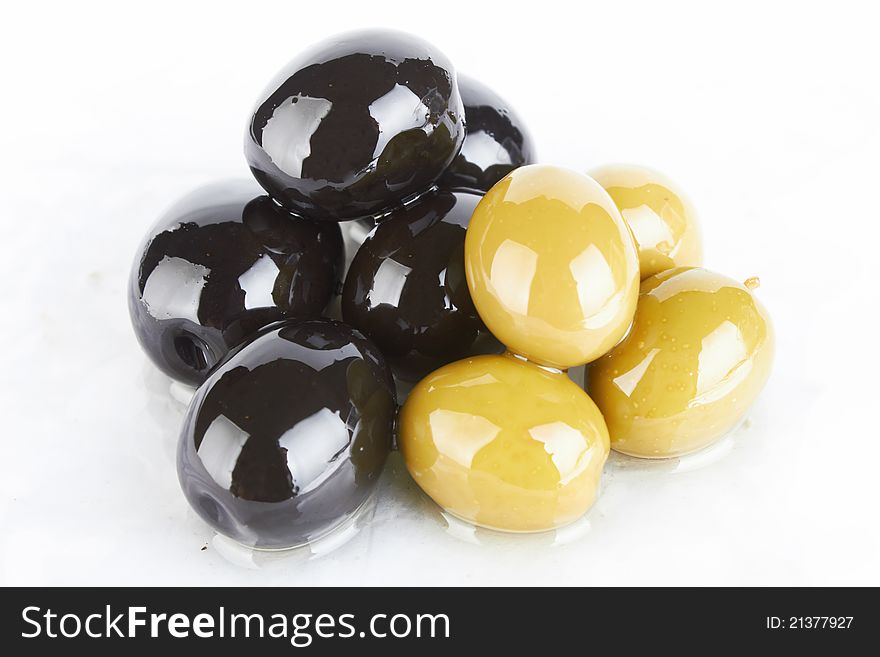 Bunch of black and green olives on a white background